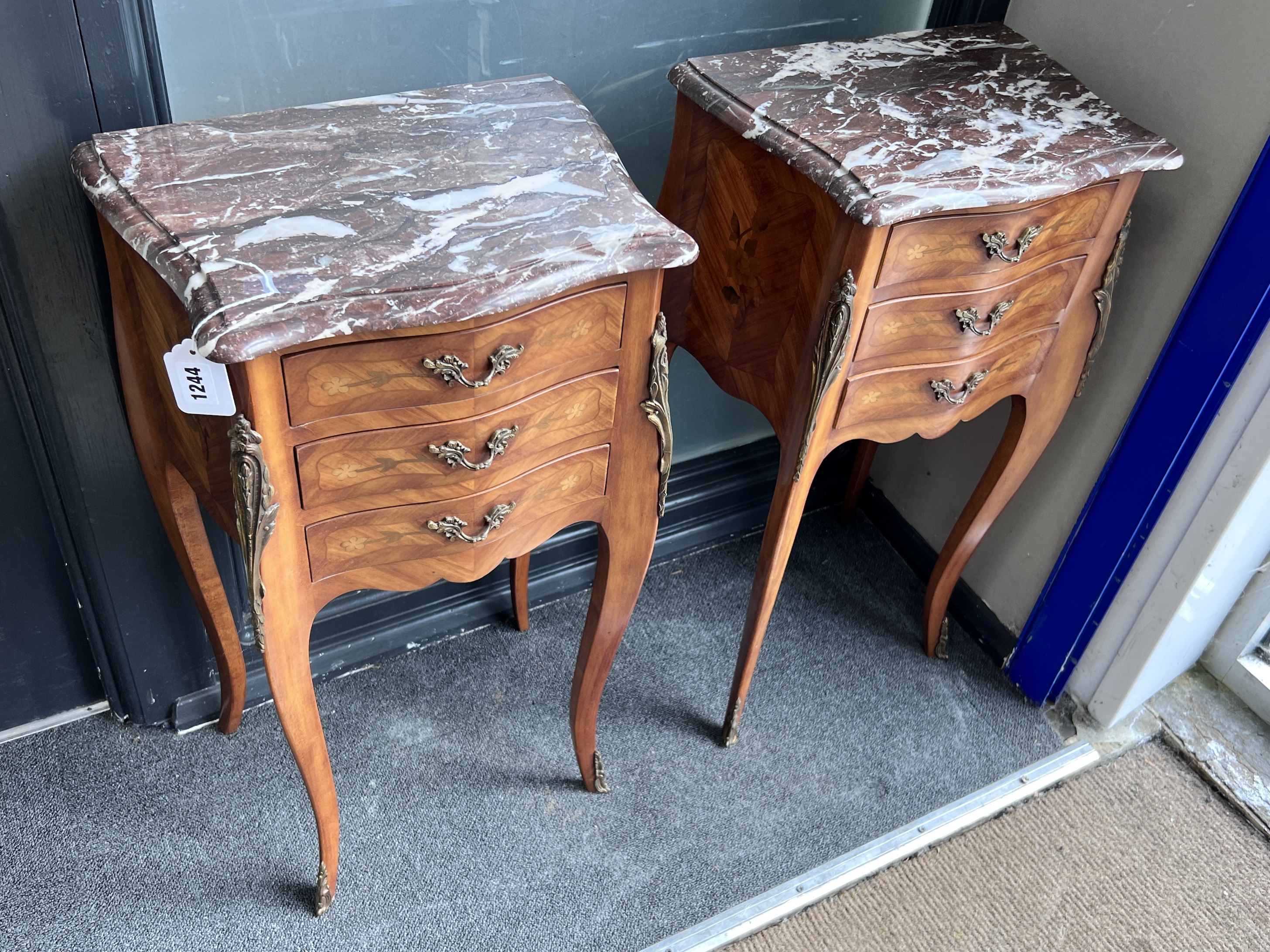 A pair of French Louis XV style marquetry inlaid serpentine rouge marble topped bedside cabinets, width 40cm, height 72cm